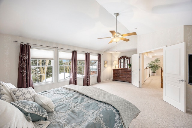 bedroom with baseboards, light colored carpet, vaulted ceiling, and a ceiling fan