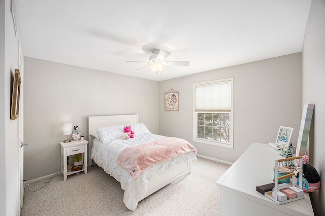 bedroom featuring ceiling fan, light colored carpet, and baseboards