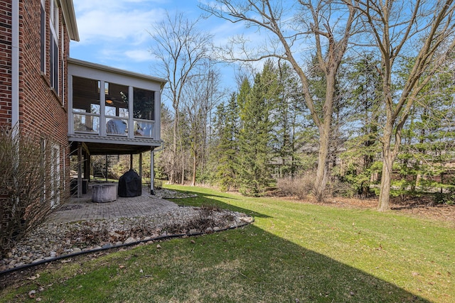 view of yard featuring a patio area and a sunroom