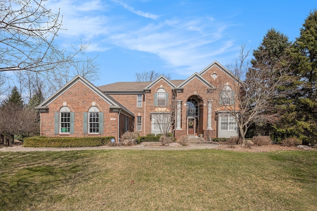 view of front of house with a front yard and brick siding