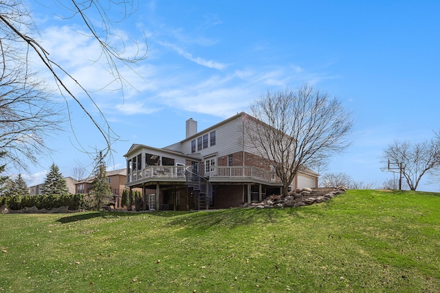 rear view of house with a chimney, stairway, brick siding, a deck, and a lawn