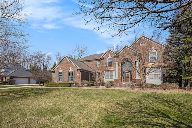 traditional-style home featuring a front yard and brick siding