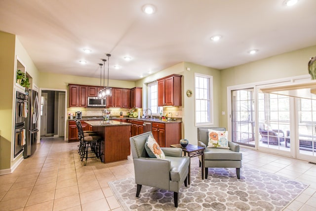 living area with light tile patterned floors and recessed lighting