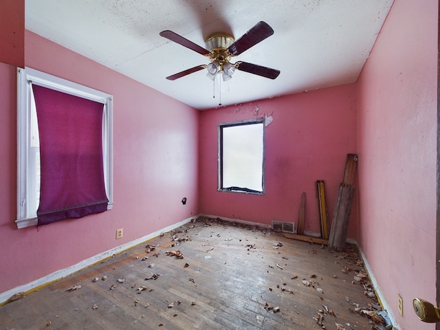 unfurnished room featuring ceiling fan and wood-type flooring