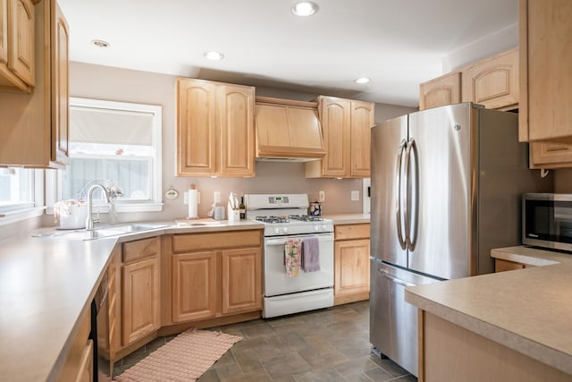 kitchen featuring light brown cabinetry, sink, custom exhaust hood, and appliances with stainless steel finishes