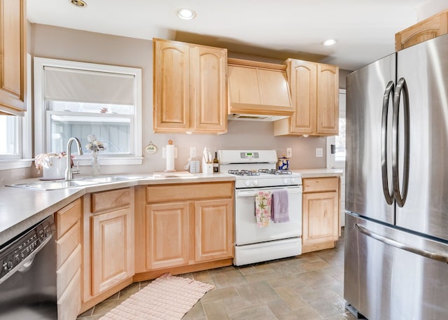 kitchen featuring light brown cabinetry, white range with gas cooktop, sink, black dishwasher, and stainless steel refrigerator