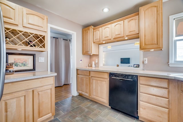 kitchen featuring light brown cabinets and black dishwasher