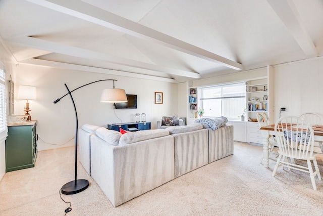 living room with lofted ceiling with beams and light colored carpet