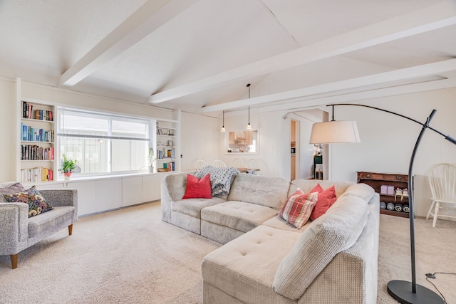 carpeted living room with vaulted ceiling with beams