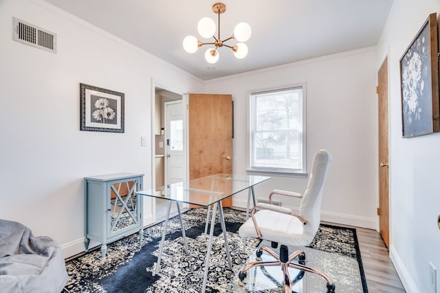 office with light hardwood / wood-style floors, crown molding, and a notable chandelier