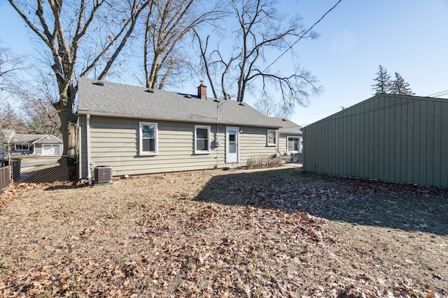 rear view of property with central AC unit