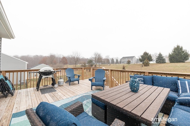 wooden deck featuring a grill