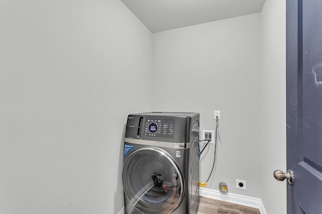 washroom featuring washer / clothes dryer and hardwood / wood-style flooring