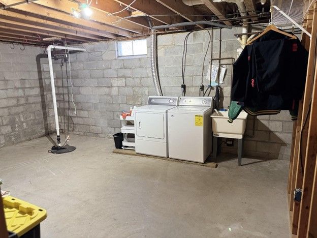 basement with washer and dryer and a sink