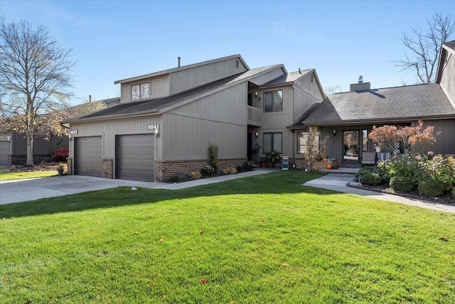 view of front of property featuring a garage and a front lawn