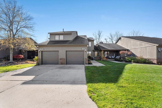 front of property featuring a front lawn and a garage