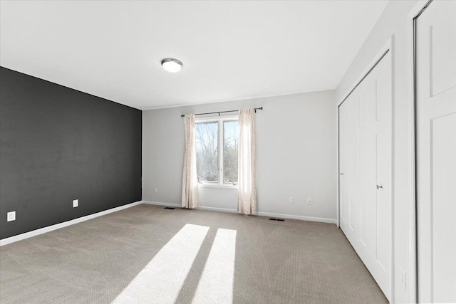 unfurnished bedroom with light carpet