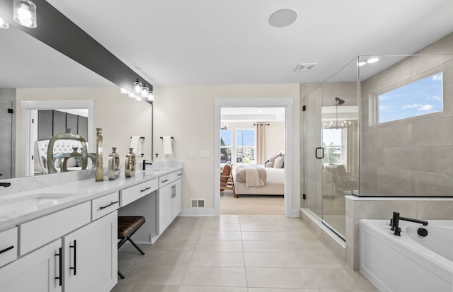 bathroom with tile patterned flooring, vanity, and shower with separate bathtub