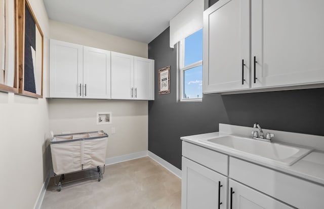 laundry room featuring sink, hookup for a washing machine, and cabinets