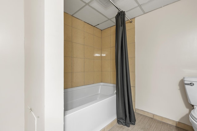 bathroom with shower / tub combo with curtain and toilet