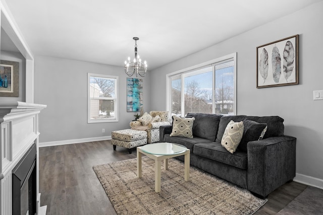 living room featuring a notable chandelier and dark wood-type flooring