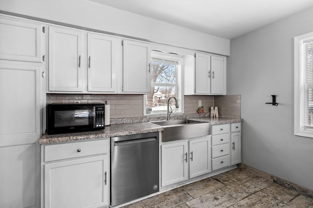 kitchen featuring stainless steel dishwasher, decorative backsplash, white cabinetry, and sink