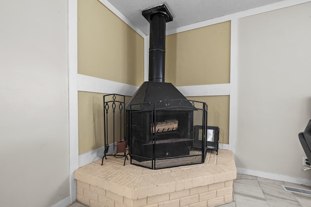 room details with a textured ceiling and a wood stove