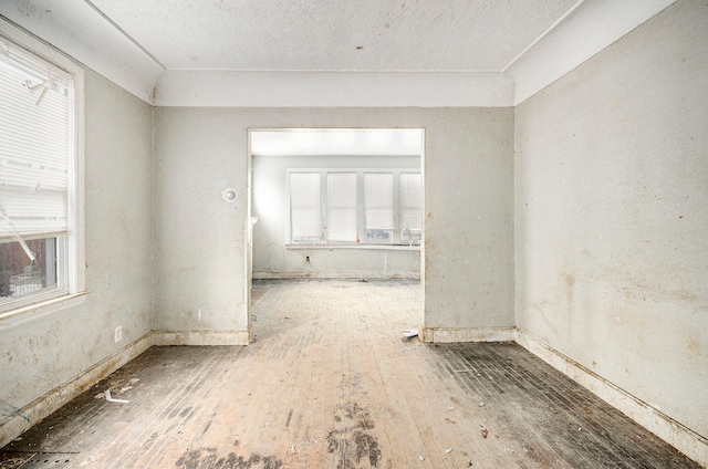 unfurnished room featuring hardwood / wood-style flooring and vaulted ceiling