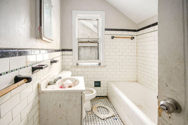 bathroom with vaulted ceiling, sink, tile walls, a bathtub, and tile patterned flooring