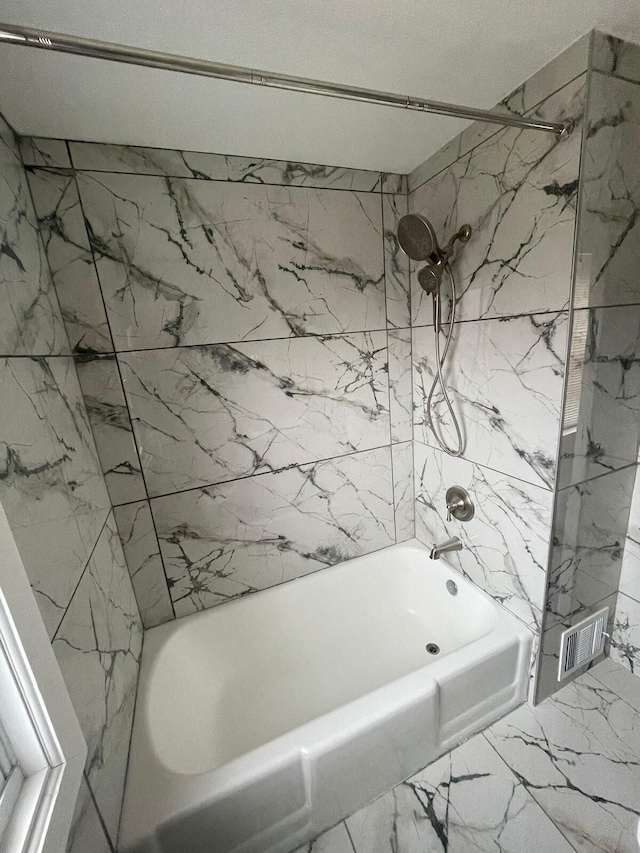 bathroom with tiled shower / bath combo