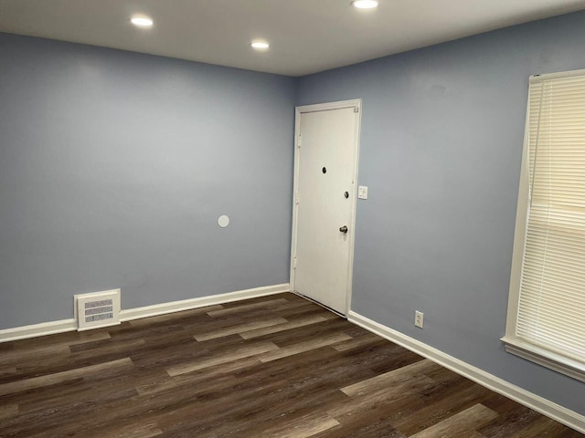 empty room featuring dark wood-type flooring