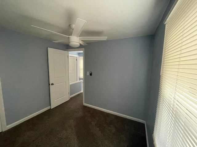 carpeted spare room with ceiling fan