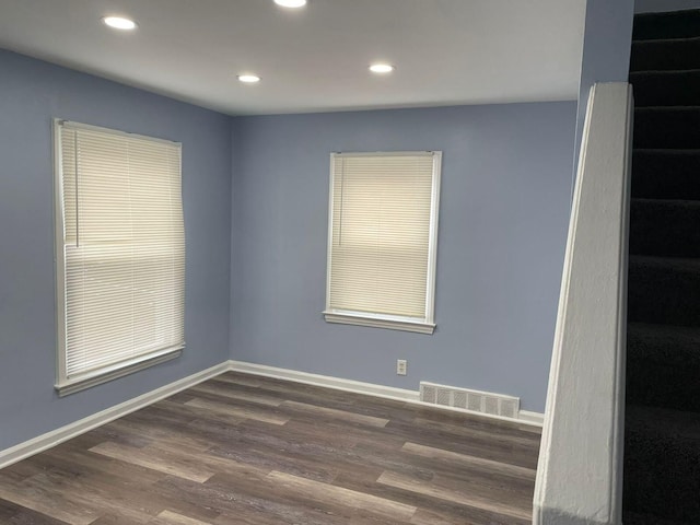 unfurnished room with dark hardwood / wood-style floors