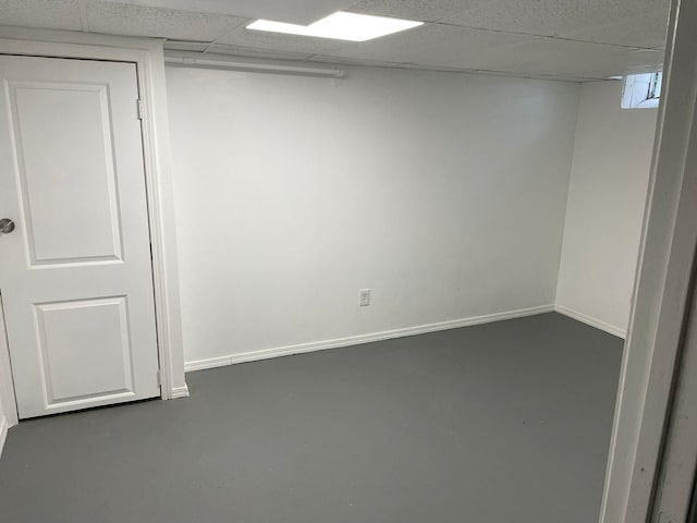 empty room featuring concrete floors and a drop ceiling