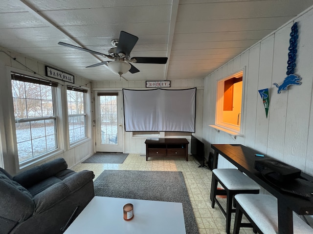 living room with wood walls and ceiling fan