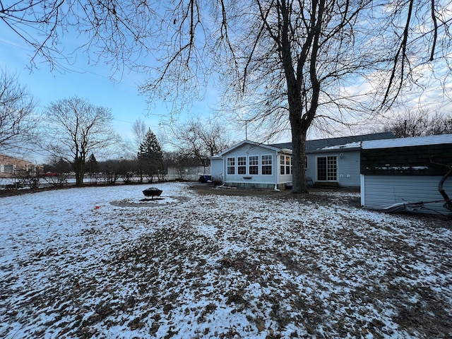 snow covered house with a carport