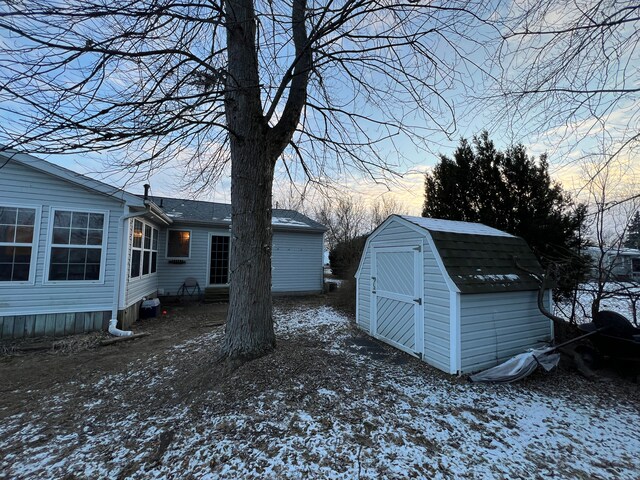 snowy yard with a storage unit