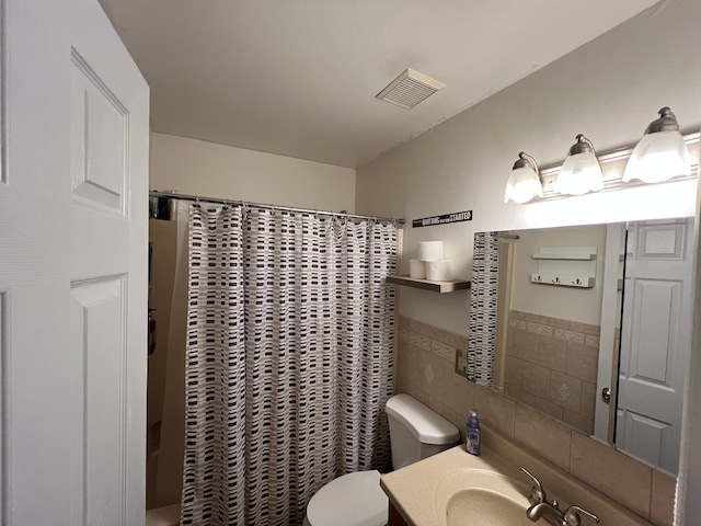 bathroom with toilet, vanity, tile walls, and a shower with curtain