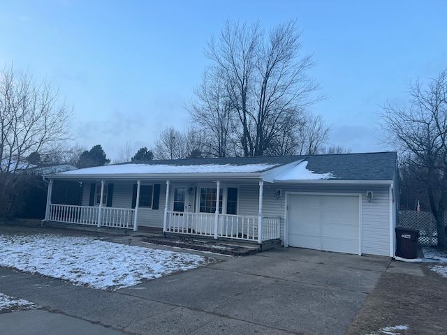 ranch-style house featuring a garage and covered porch