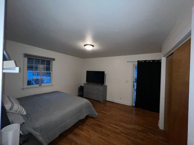 bedroom featuring dark hardwood / wood-style flooring