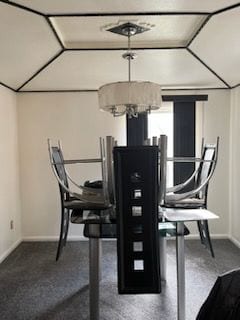 dining area with a chandelier and vaulted ceiling