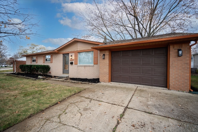 ranch-style home featuring a garage and a front lawn