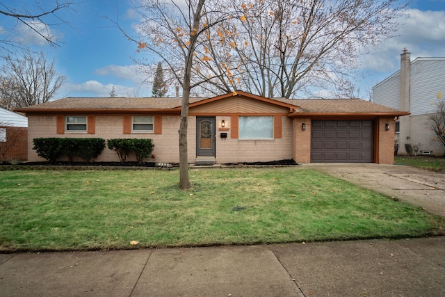 ranch-style house with a garage and a front lawn