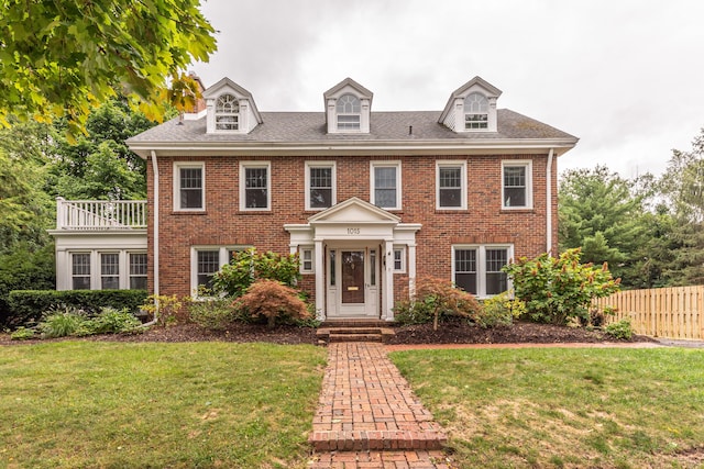 colonial home with a front lawn