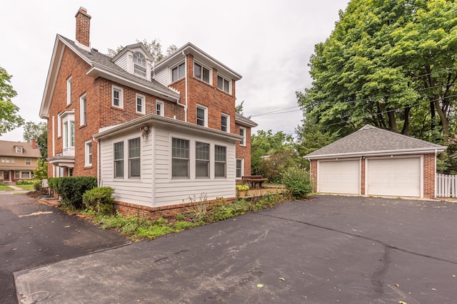 view of home's exterior featuring a garage and an outbuilding