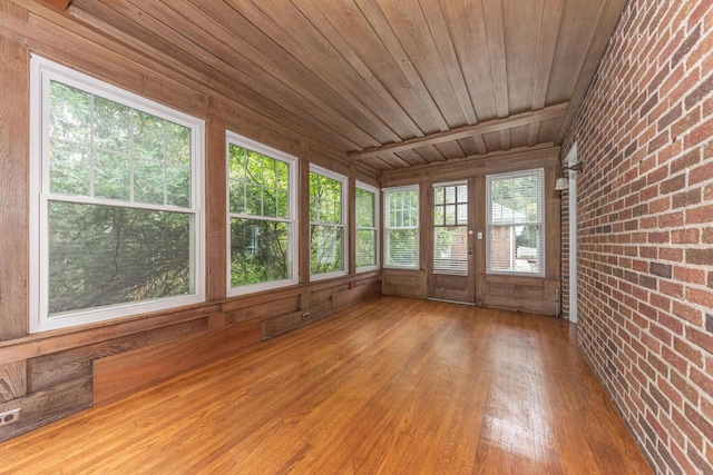 unfurnished sunroom featuring wood ceiling