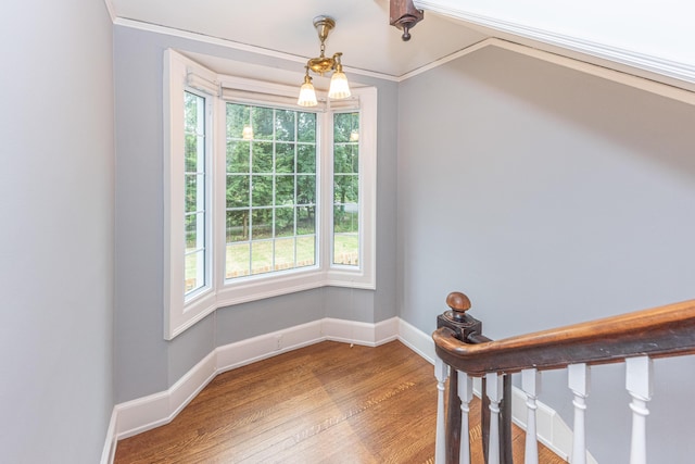 interior space featuring hardwood / wood-style flooring, lofted ceiling, and crown molding