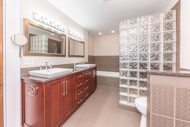 bathroom with tile patterned floors, walk in shower, vanity, and toilet