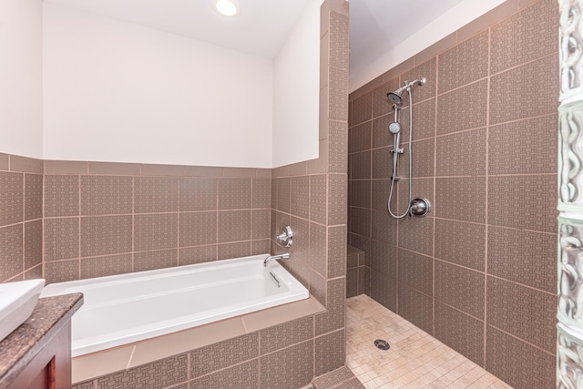 bathroom featuring tile patterned flooring, vanity, and tile walls