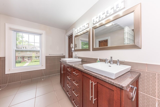 bathroom with tile patterned floors, vanity, and tile walls